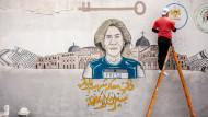 Palestinian artist paints a mural of Al-Jazeera journalist Shireen Abu Akleh in Khan Yunis in the southern Gaza Strip