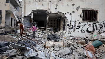  Children walk amid the rubble of a building destroyed during an Israeli raid at the Nur Shams camp for Palestinian refugees near the occupied West Bank city