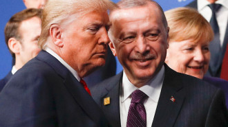 US President Donald Trump (L) and Turkey's President Recep Tayyip Erdogan (R) leave the stage after the family photo to head to the plenary session at the NATO summit in London 