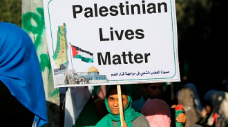 A Palestinian woman holding a placard takes part in a protest against Israel's plan to annex parts of the occupied West Bank, near the Erez crossing with Israel near Beit Hanun in the northern Gaza Strip on July 9, 2020. (MOHAMMED ABED/AFP/via Getty)