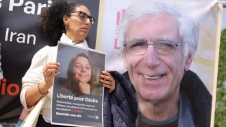 A supporter holds a placard bearing a portrait of French teacher Cecile Kohler, detained along with her partner Jacques Paris in Iran, during a rally in their support in Paris on May 14, 2023. (Photo by THOMAS SAMSON/AFP via Getty Images)