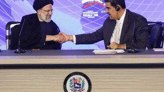 Ebrahim Raisi (left) shakes hands with Nicolás Maduro (right)