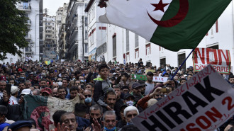 Algerian anti-government protesters take part in a demonstration in the capital Algiers, on 26 February, 2021. [Getty]