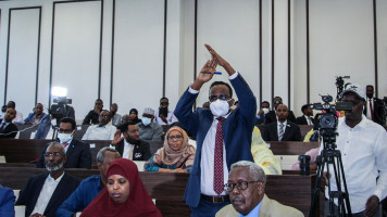 A Somali member of Parliament gestures as he attends a special assembly