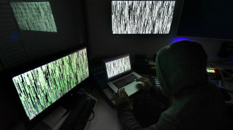 A hacker with multiple computer screens