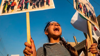 A Syrian Yazidi girl marches during a demonstration near the Syrian-Turkish border on 3 August 2018, commemorating the fifth anniversary of the Islamic State (IS) attacks on SInjar. [Getty]