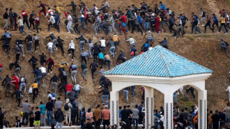 Migrants try to reach the border between Morocco and the Spanish enclave of Ceuta on 18 May, 2021. [Getty]