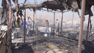 People were scrambling to put out the fire in the camp [Getty]