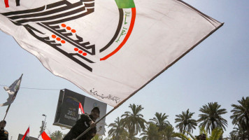 Members of Iraq's PMF march in a symbolic funerary parade in Baghdad on 29 June, 2021, in remembrance of those killed in a recent US raid. [Getty]