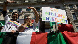 Members of the British gay, lesbian, bisexual, and transgender Muslim group Imaan wave from atop a float during the EuroPride parade in London on 6 July, 2019. [Getty]