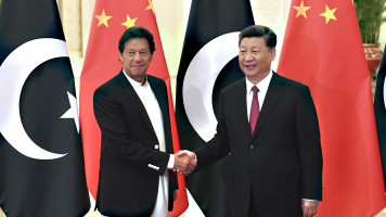 China's President Xi Jinping, right, shakes hands with Pakistan's Prime Minister Imran Khan before a meeting at the Great Hall of the People on 28 April 2019 in Beijing, China. [Getty]