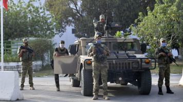 Tunisian soldiers cordon-off the Parliament in the capital Tunis on July 26, 2021, following a move by the President to suspend the country's parliament and dismiss the Prime Minister. - Tunisia was plunged deeper into crisis as President Kais Saied suspended parliament and dismissed Prime Minister Hichem Mechichi late July 25, prompting the country's biggest political party to decry a "coup d'etat". (Photo by FETHI BELAID / AFP) (Photo by FETHI BELAID/AFP via Getty Images)