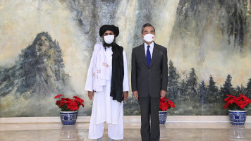 Taliban co-founder Mullah Abdul Ghani Baradar, left, and Chinese Foreign Minister Wang Yi pose for a photo during their meeting in Tianjin, China, Wednesday, July 28, 2021. [Li Ran/Xinhua via AP]