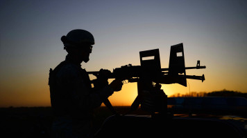 An Afghan National Security Forces soldier mans a machinegun mounted on a vehicle while patrolling an area during a military operation in Herat province. [Getty]