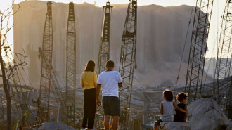 TOPSHOT - A couple and children contemplate the damage in front of the grain silo at the port of Beirut on August 13, 2020, more than a week after a massive blast ravaged the port and parts of the Lebanese capital. - The massive chemical blast on August 4 at a Beirut port warehouse left scores of people dead or wounded. (Photo by - / AFP) (Photo by -/AFP via Getty Images)