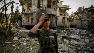 An Afghan security personnel stands guard at the site a day after a car bomb explosion in Kabul on 4 August, 2021. On 15 August, the Afghan government collapsed and the Taliban took Kabul. [Getty]