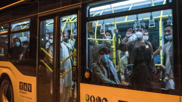 Afghan refugees are seen onboard a bus upon arrival at Skopje International Airport, after being evacuated from Kabul following the Taliban takeover of Afghanistan [Getty Images]