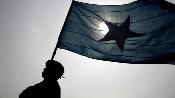 A policeman marches holding a Somali flag during a parade in Mogadishu, 11 December 2007. [Getty]