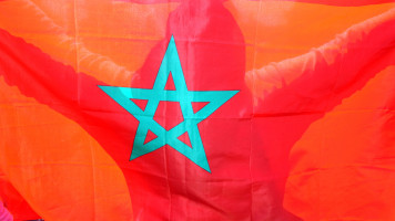 A Moroccan woman holds a Moroccan flag during a demonstration against terrorism on May 7, 2011. [Getty]