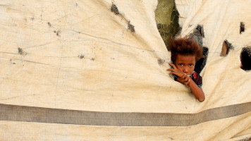 A Yemeni child who fled fighting between Yemen's armed rebels and pro-government forces in Hodeida, is pictured at a makeshift camp in the district of Abs, in Yemen's northwestern Hajjah province on 13 May 2019. [Getty]