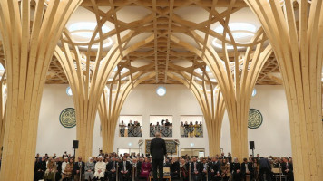 Turkish President Recep Tayyip Erdogan makes a speech as he and his wife Emine Erdogan (not seen) attend official opening ceremony of Cambridge Central Mosque in London [Getty Images]