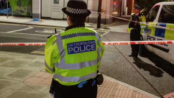 A British police officer stands next to a police cordon close to where Sabina Nessa was killed