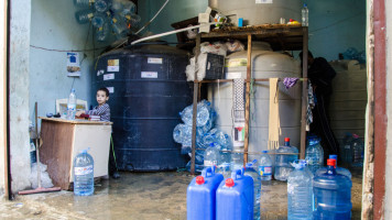 A young boy seen selling clean water in a shop. Lebanon host over a million of refugees that had fled from the neighbouring country seeking safety [Getty Images]