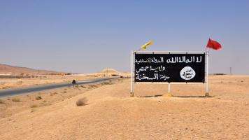 Islamic State (IS) group poster in the central Syrian town of Al-Sukhnah