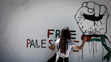 Palestinian artists paint murals in Gaza City, June 8, 2021.[Getty]