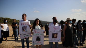 A group of people gather in front of Ramon Prison during a demonstration demanding the release of detained Palestinian women, including Anhar al-Deek, 25, who is in her last month of pregnancy [Getty Images]