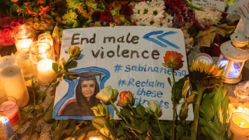 A placard with the words "End male violence is seen during Sabina Nessa's vigil in London. People attend the vigil of Sabina Nessa, a 28-year-old teacher who was killed in Kidbrooke as she walked to a pub in London 5 mins from her home