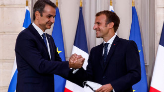 Greek Prime Minister Kyriakos Mitsotakis (L), shakes hands with French President Emmanuel Macron following a signing ceremony of a new defence deal at The Elysee Palace in Paris on September 28, 2021