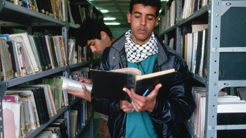 Students Reading in the Stacks of a Library (Photo by Peter Turnley/Corbis/VCG via Getty Images)