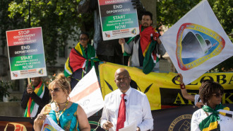 Anthony Brown, founder of Windrush Defenders Legal C.I.C., reads a pledge to Windrush campaigners in front of the statue of Nelson Mandela in Parliament Square on 23rd June 2021 in London [Getty Images]