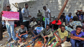 African migrants stage a demonstration outside the headquarters of the United Nations Refugee Agency (UNHCR) in the Siraj area of the Libyan capital Tripoli, calling for their repatriation, on October 9, 2021 [Getty Images]