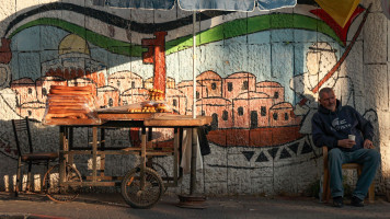 A Palestinian street vendor waits for customers in the West Bank city of Ramallah on October 5, 2021