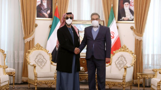 Secretary of Iran's Supreme National Security Council Ali Shamkhani, right, and United Arab Emirates' top national security adviser Sheikh Tahnoon bin Zayed Al Nahyan shake hands for the media prior to their meeting in Tehran, Iran, Monday, Dec. 6, 2021