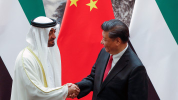 Abu Dhabi's Crown Prince Mohammed bin Zayed (L) shakes hands with Chinese President Xi Jinping after witnessed a signing ceremony at the Great Hall of the People in Beijing on July 22, 2019. 