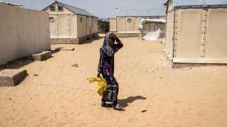 A young girl walks through the Diougop relocation camp outside of Saint Louis on August 11, 2021 