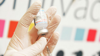 A coronavirus vaccine shot being drawn from a vial