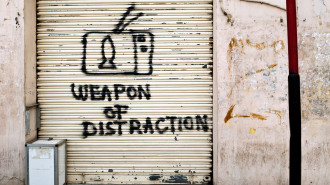 Graffiti critical of television on a shuttered shop in Beirut, Lebanon.