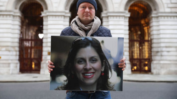 Nazanin Zaghari-Ratcliffe's husband holding a large photo of her