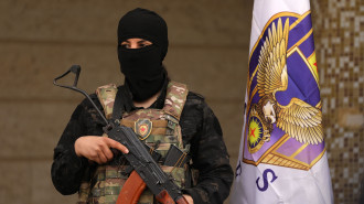 Syrian Democratic Forces (SDF) fighters stand guard during a press conference in Syria's northeastern city of Hasakeh in which the SDF said the Ghwayran prison is on their control, on January 31, 2022.