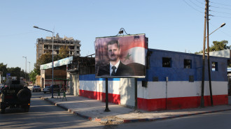 A poster with an image of Syria's President Bashar al-Assad in a street. Marina Lystseva/TASS (Photo by Marina Lystseva\TASS via Getty Images)