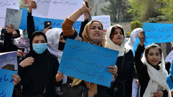 Afghan women and girls take part in a protest in front of the Ministry of Education in Kabul on March 26, 2022