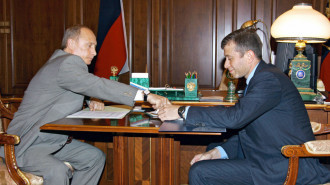 Russian President Vladimir Putin (L) speaks with Roman Abramovich, governor of the Chukotka region, billionaire and owner of the Chelsea Football Club during their meeting in Moscow, 27 May 2005.