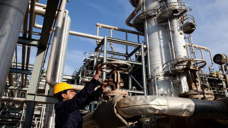 A worker monitors pressure levels at the Kar Refinery in Erbil, Iraq