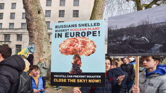 A protester holds a placard warning of a nuclear disaster