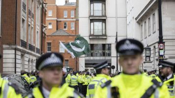 Police officers take security measures as people stage a protest against the Prime Minister Imran Khan's voting out by Pakistanâs parliament in a no-confidence motion in front of the house of Former Prime Minister of Pakistan Nawaz Sharif in London