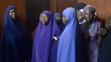 Muslim students stand outside the courtroom waiting for the judgment at the Lagos High Court on October 17, 2014. A judge in Lagos on Friday upheld a ban on the Muslim headscarf in state-run schools, ruling that the restriction did not breach students' civil rights. The